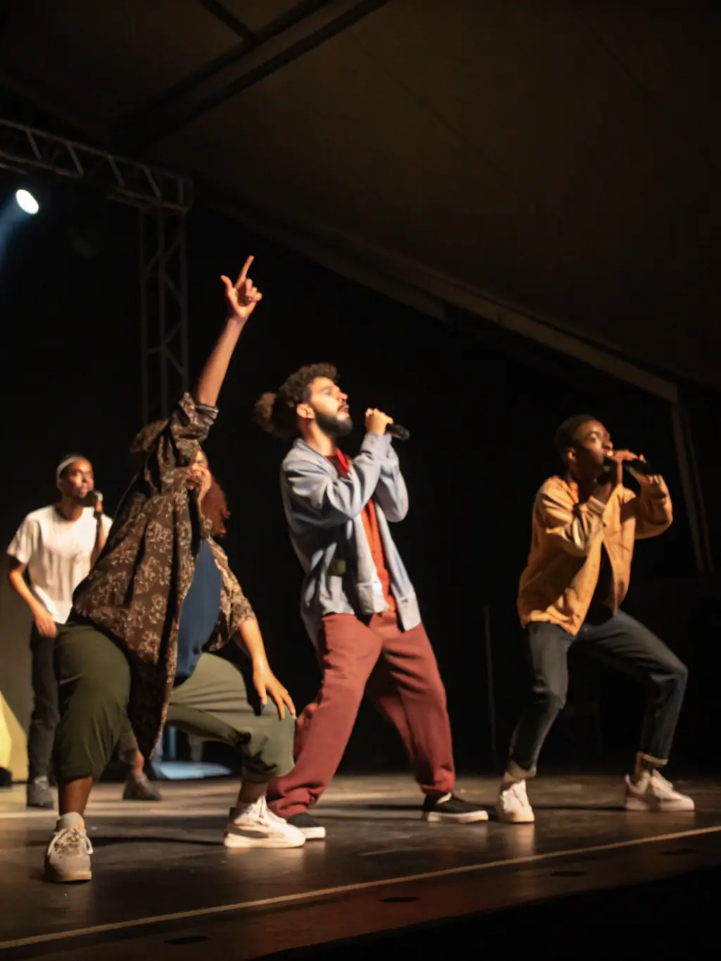 A vibrant image of community members rehearsing on stage, with diverse participants engaging in acting and stagecraft, showcasing TAC'ON'ART's Community Theater Programs.
